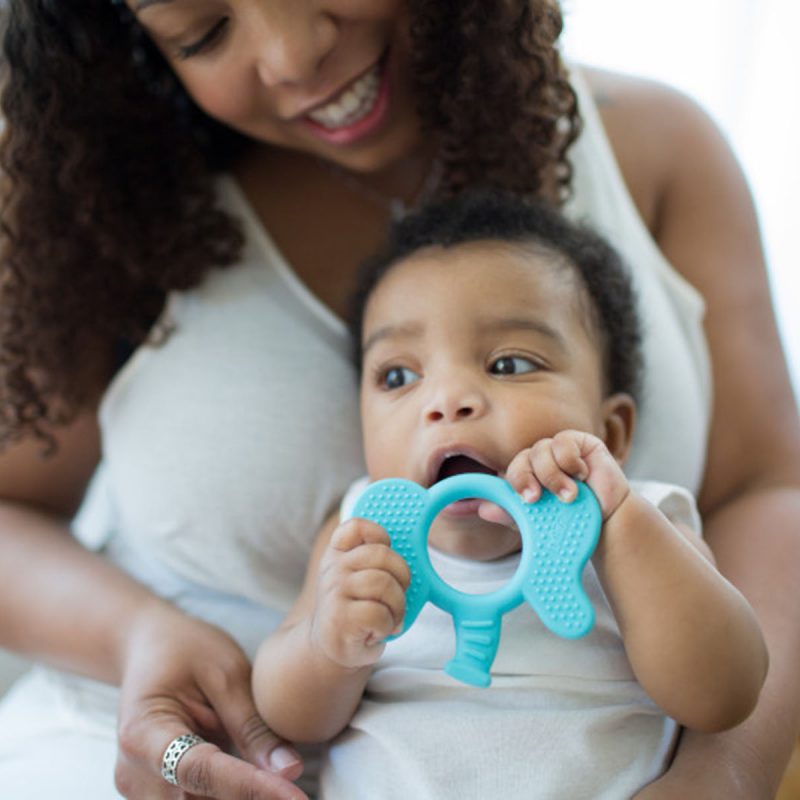 baby chewing on flexie friends teether