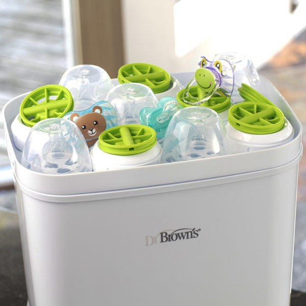 Upclose photo of sterilizer open with parts, nipples, and pacifiers on tray